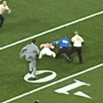 Super Bowl suffers delay after partial streakers run onto field and are tackled by security as Mahomes watches on