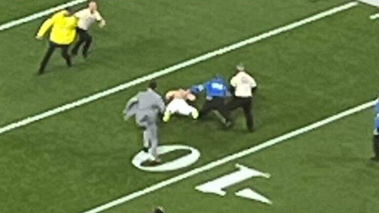 Super Bowl suffers delay after partial streakers run onto field and are tackled by security as Mahomes watches on