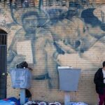 Migrants Camp in City Streets as Biden’s Shelters Overflow and Gang Violence Grows